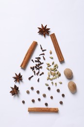 Christmas tree made of different spices on white table, flat lay