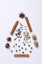 Photo of Christmas tree made of different spices on white table, flat lay