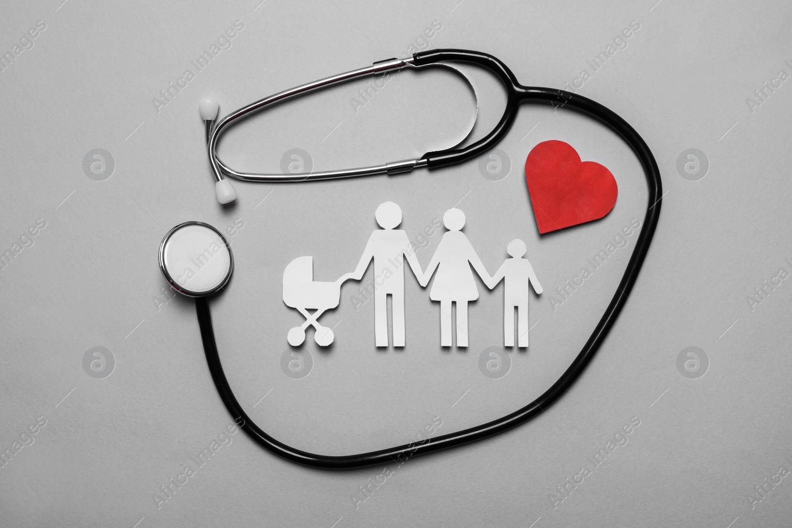 Photo of Paper family cutout, red heart and stethoscope on grey background, flat lay. Insurance concept