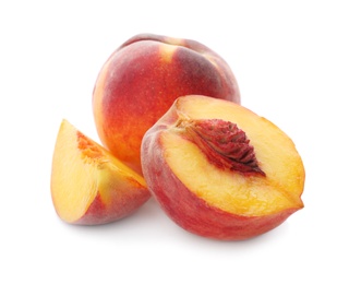 Whole and cut ripe peaches isolated on white