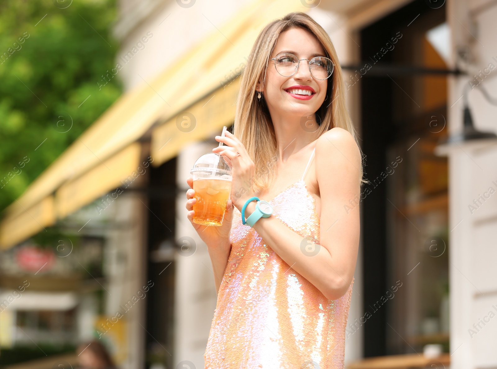 Photo of Young woman with cup of tasty lemonade outdoors