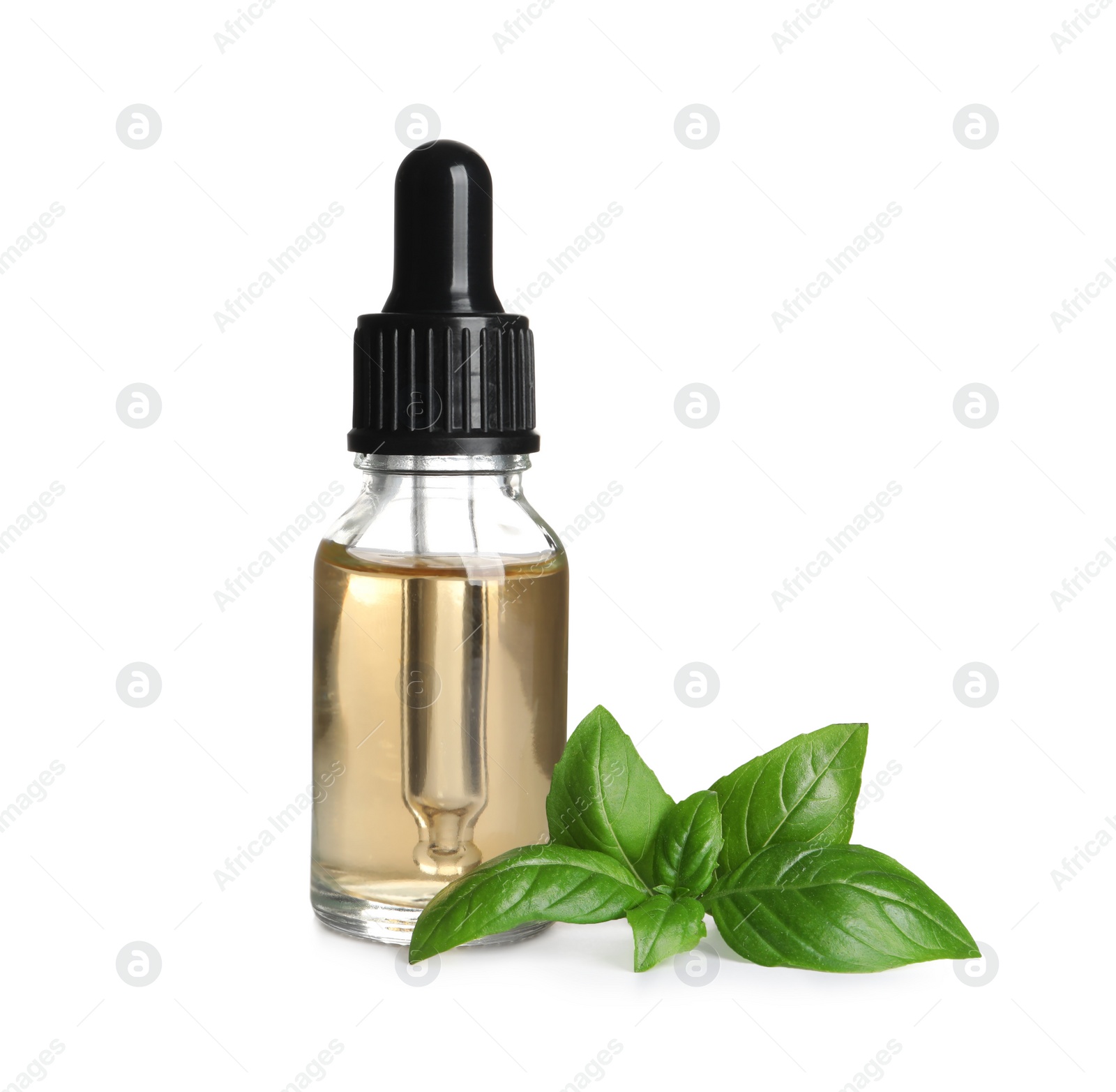 Photo of Glass bottle of basil essential oil and leaves on white background