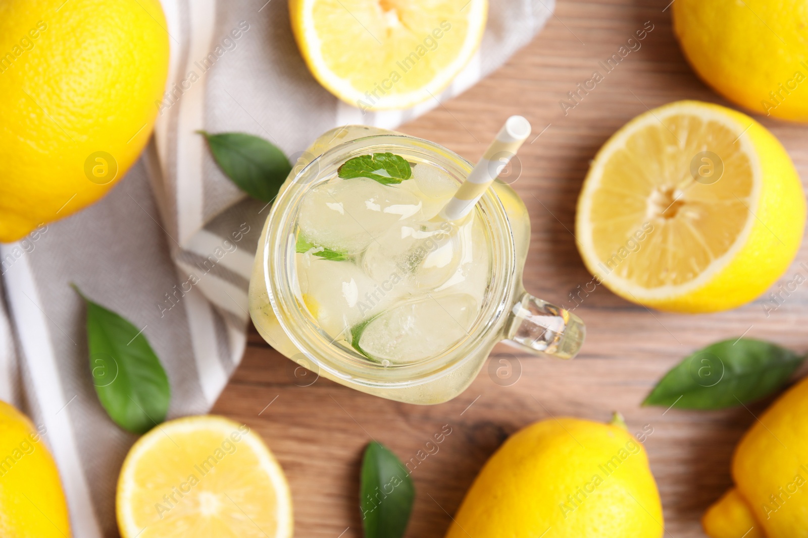 Photo of Cool freshly made lemonade and fruits on wooden table, flat lay