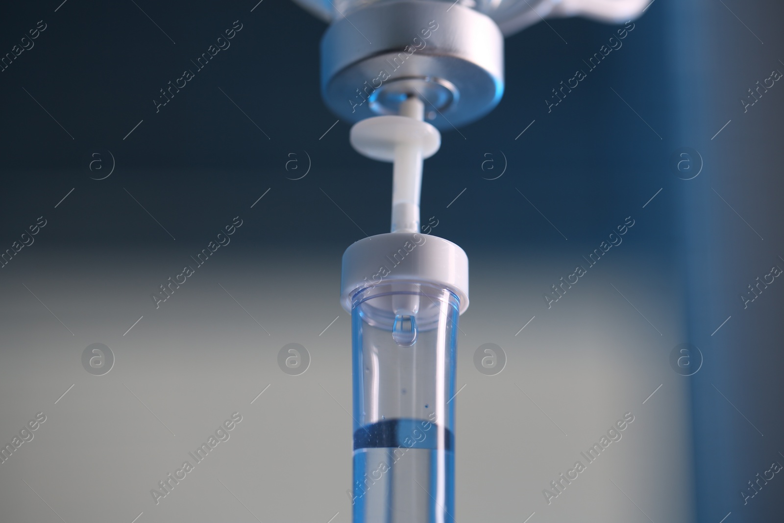 Photo of IV drip against blurred light background, closeup