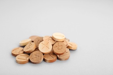 Pile of wooden runes on light grey background