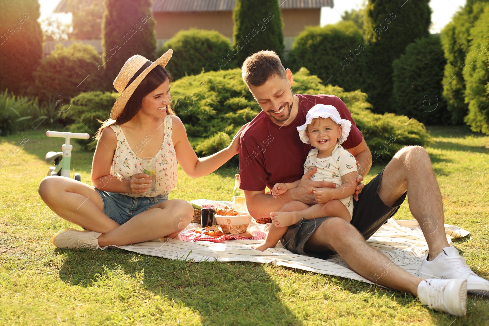 Photo of Happy family having picnic in garden on sunny day