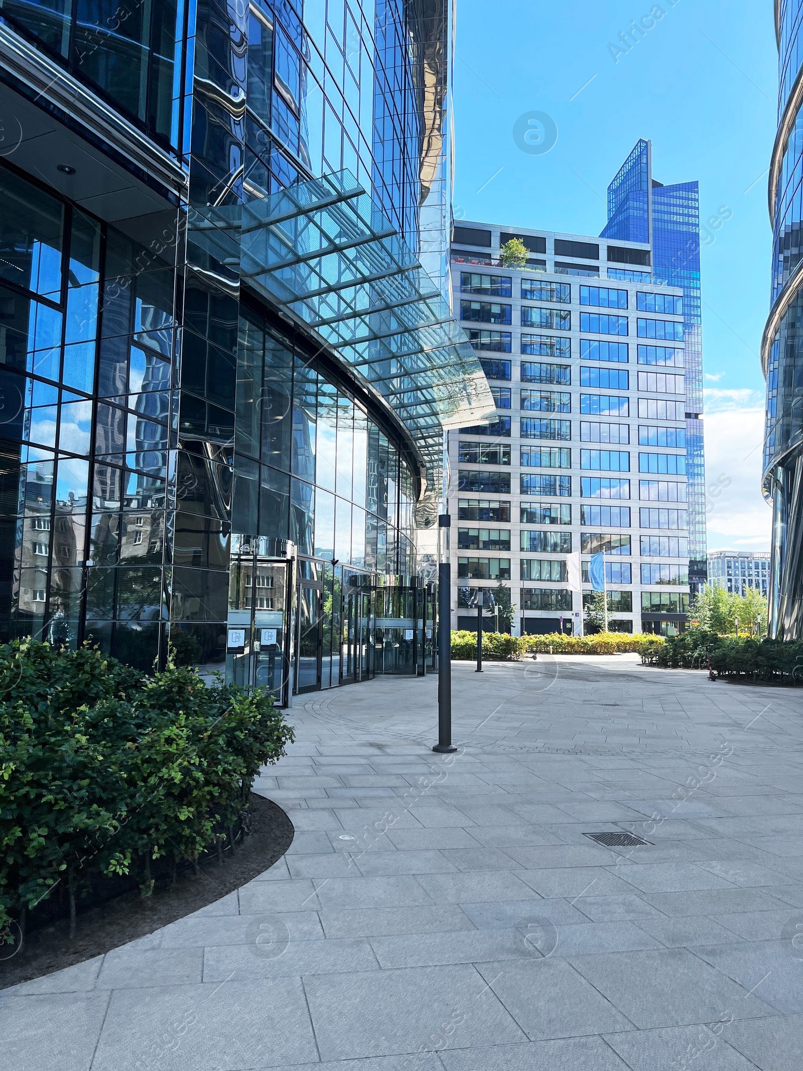 Photo of View of city street with modern buildings on sunny day