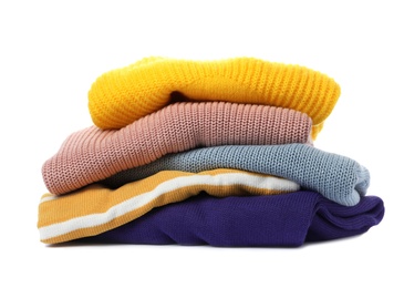 Photo of Stack of folded knitted sweaters on white background