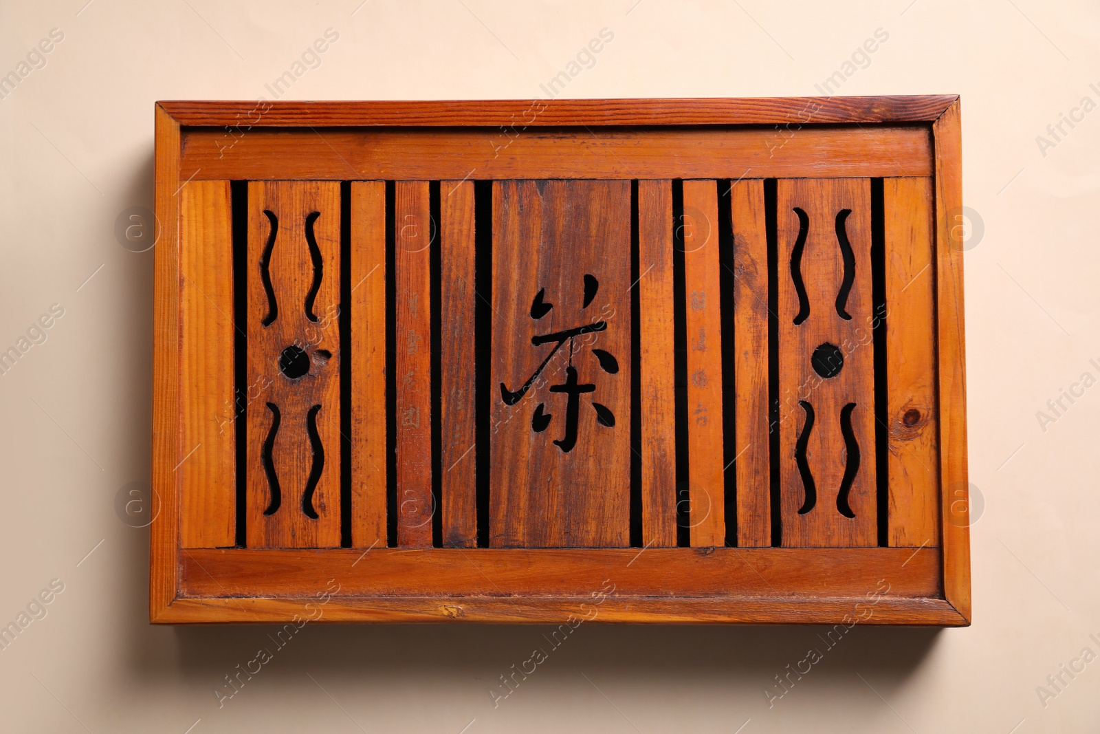 Photo of Wooden tray for traditional tea ceremony on beige background, top view