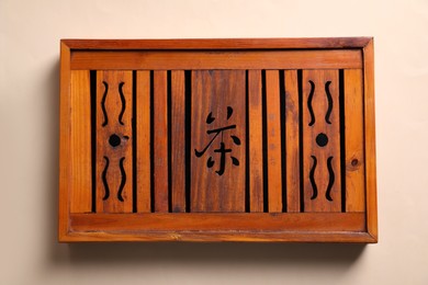 Wooden tray for traditional tea ceremony on beige background, top view