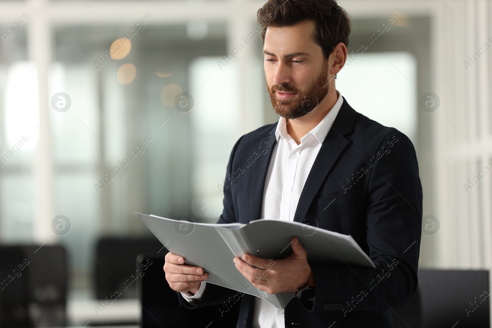 Photo of Handsome man with folder in office, space for text. Lawyer, businessman, accountant or manager