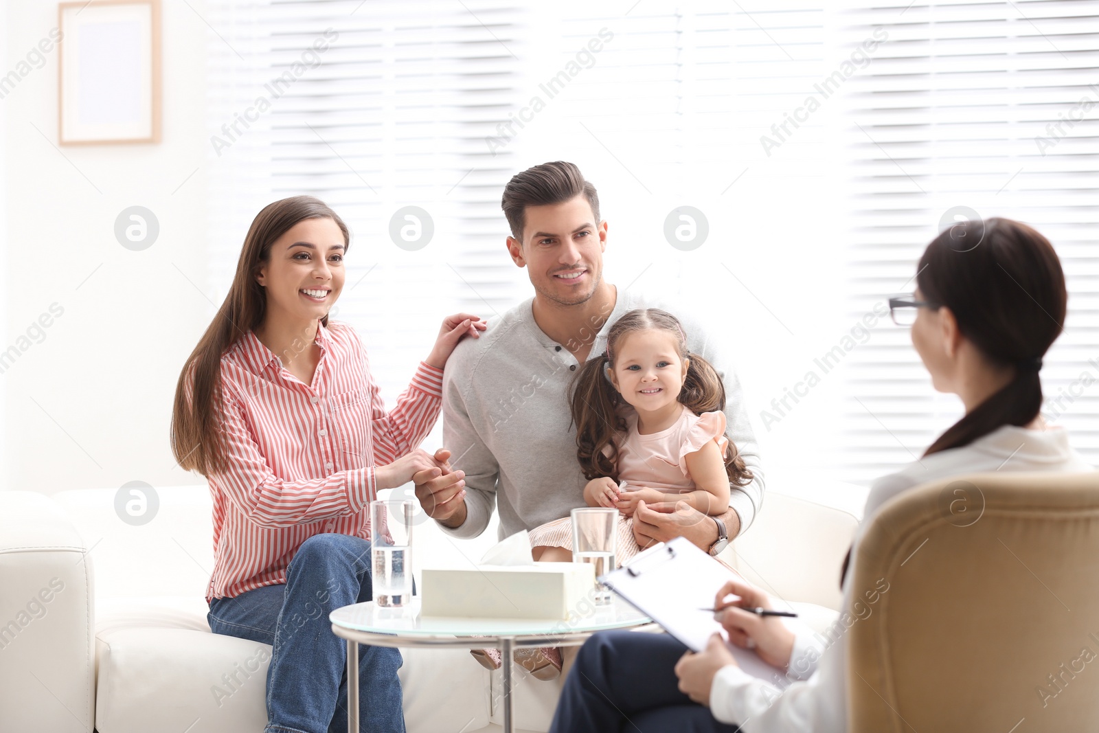 Photo of Professional psychologist working with family in office