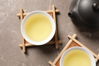 Photo of Cups and teapot of Tie Guan Yin oolong on table, top view