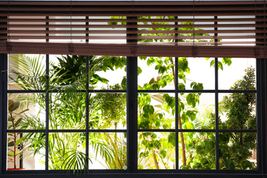 Photo of Beautiful view through window on garden in morning