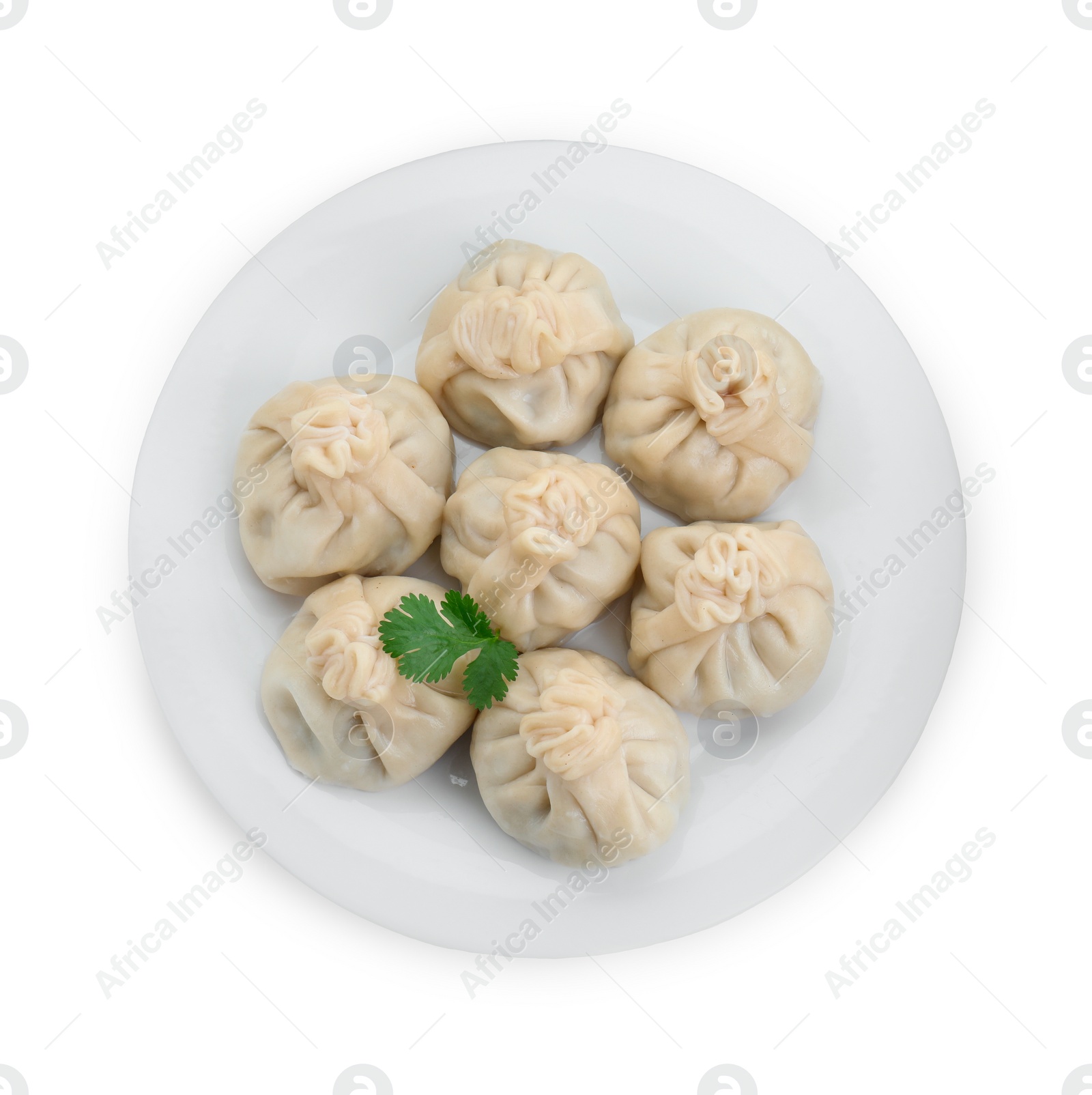 Photo of Plate with many tasty khinkali (dumplings) and parsley isolated on white, top view. Georgian cuisine