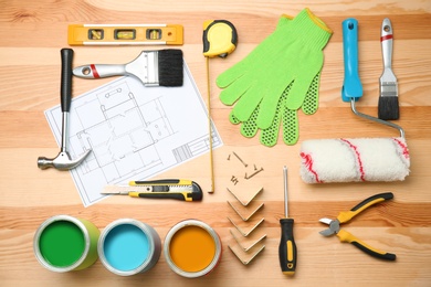 Set of decorator's tools and project drawing on wooden background