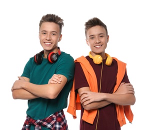 Photo of Teenage twin brothers with headphones on white background