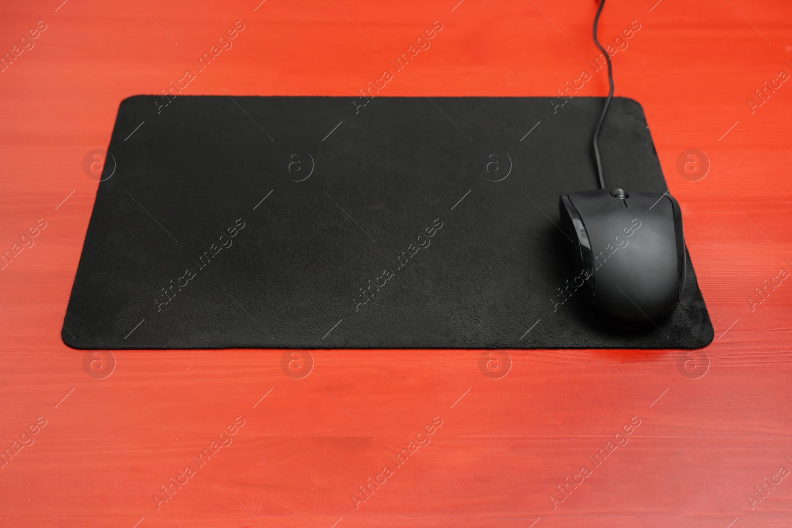 Photo of Blank mat and modern computer mouse on color background
