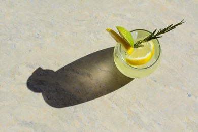 Photo of Summer refreshing lemonade on light grey table, top view. Space for text