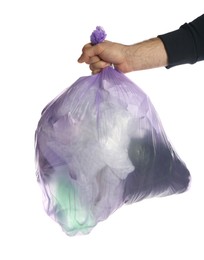 Man holding trash bag filled with garbage on white background, closeup