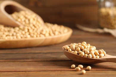 Soy on wooden table, closeup. Space for text