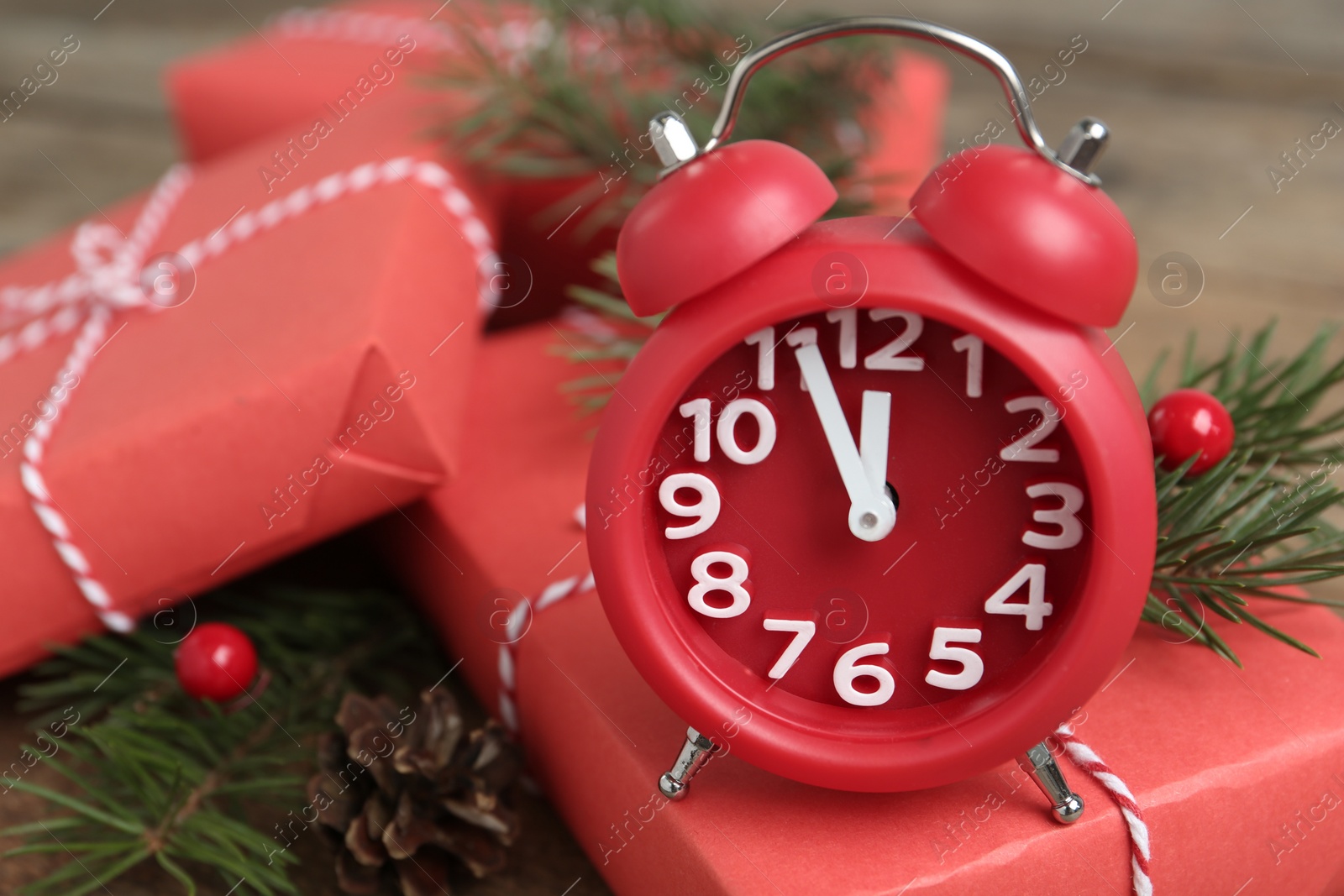 Photo of Beautiful composition with alarm clock and Christmas gifts, closeup. Boxing day