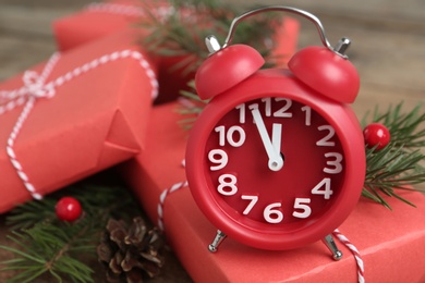 Photo of Beautiful composition with alarm clock and Christmas gifts, closeup. Boxing day