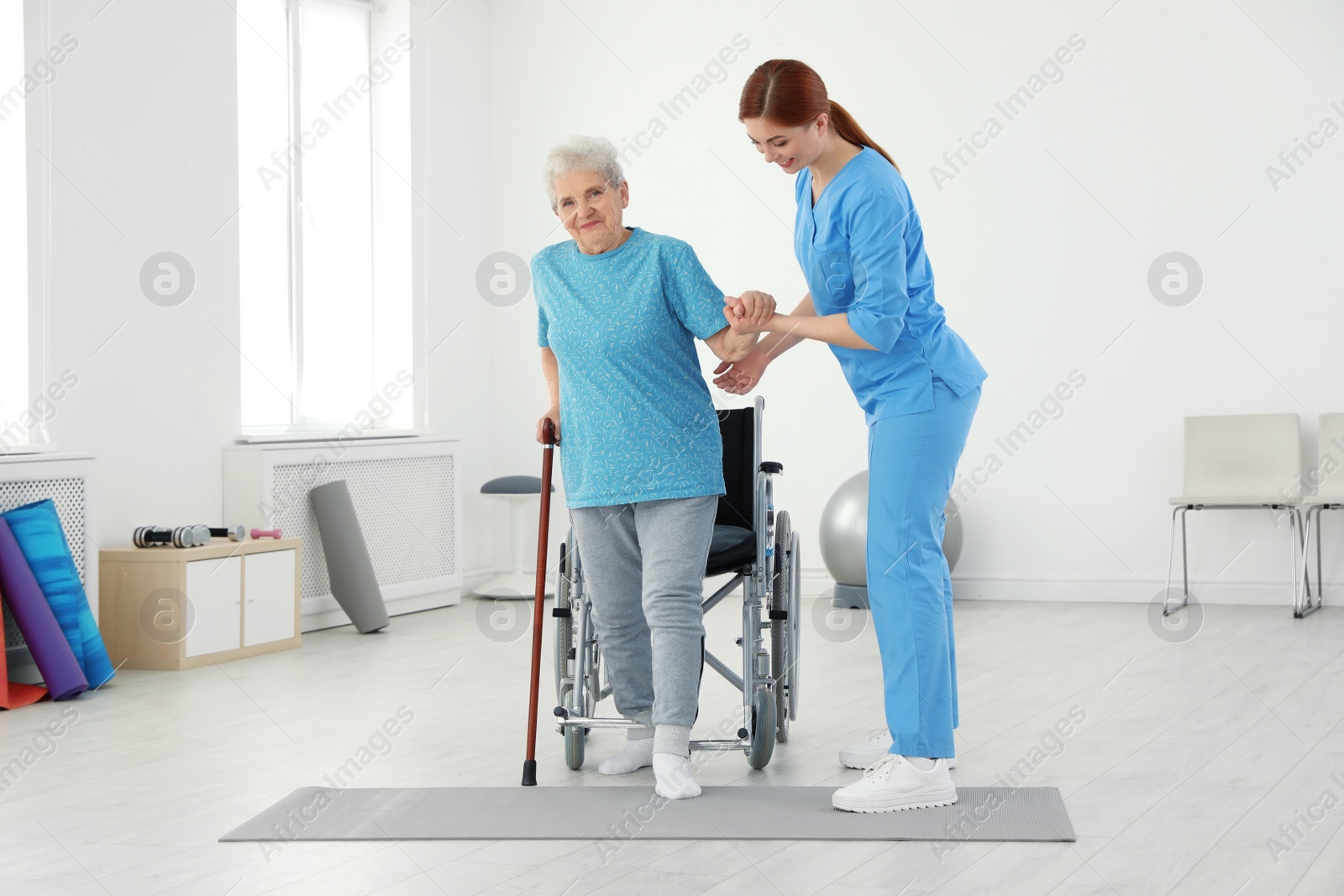 Photo of Professional physiotherapist working with elderly patient in rehabilitation center