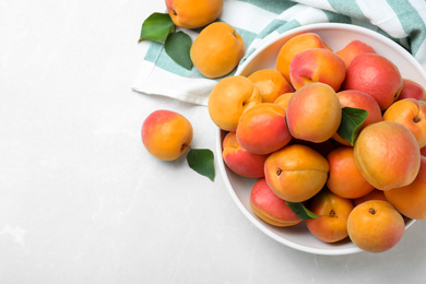 Delicious fresh ripe apricots on white table, flat lay