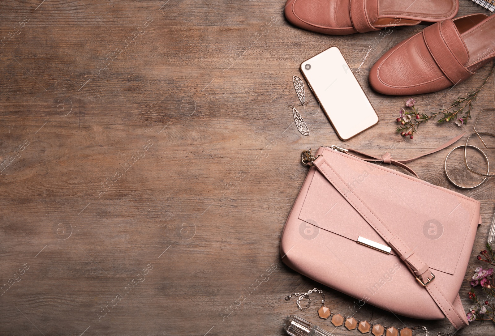 Photo of Flat lay composition with stylish shoes, small woman's bag and smartphone on wooden background. Space for text