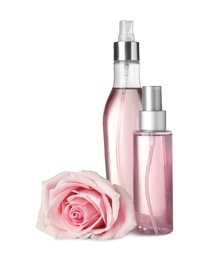 Photo of Bottles with rose essential oil and flower on white background