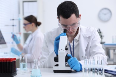 Scientist working with microscope in laboratory. Medical research