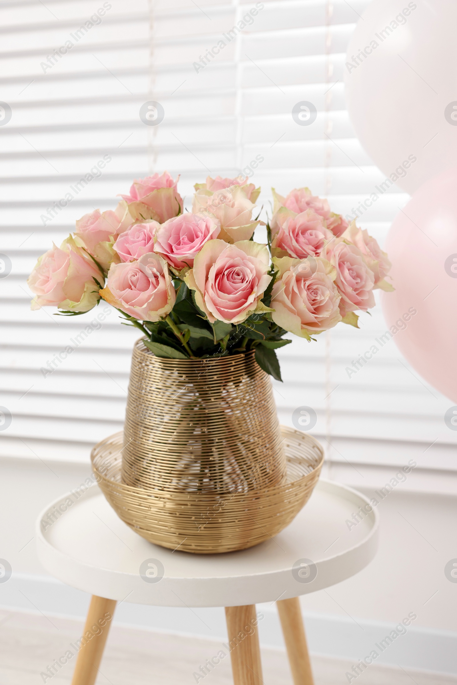 Photo of Beautiful bouquet of rose flowers on coffee table in room. Happy birthday