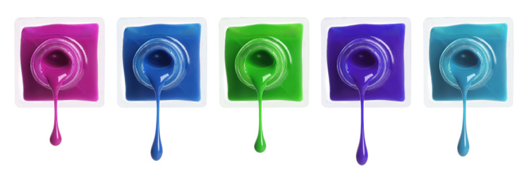 Image of Set of different nail polishes dripping on white background. Banner design