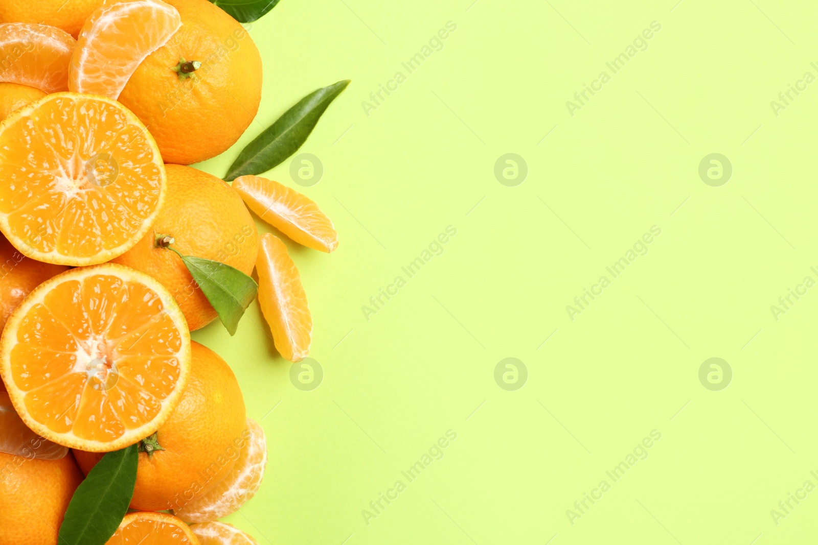 Photo of Composition with tangerines and leaves on color background, flat lay. Space for text