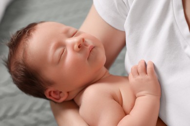 Mother holding her cute newborn baby, closeup