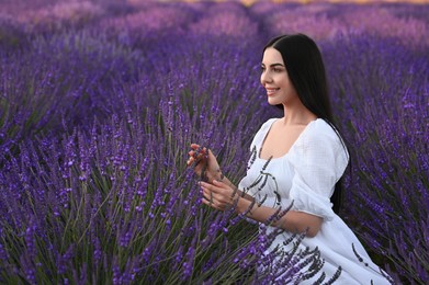Photo of Portrait of beautiful young woman in lavender field