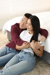 Photo of Lovely young couple on floor at home