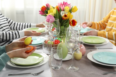 Photo of Festive table setting. Women celebrating Easter at home, closeup