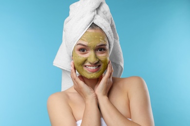 Photo of Beautiful woman with mask on face against color background