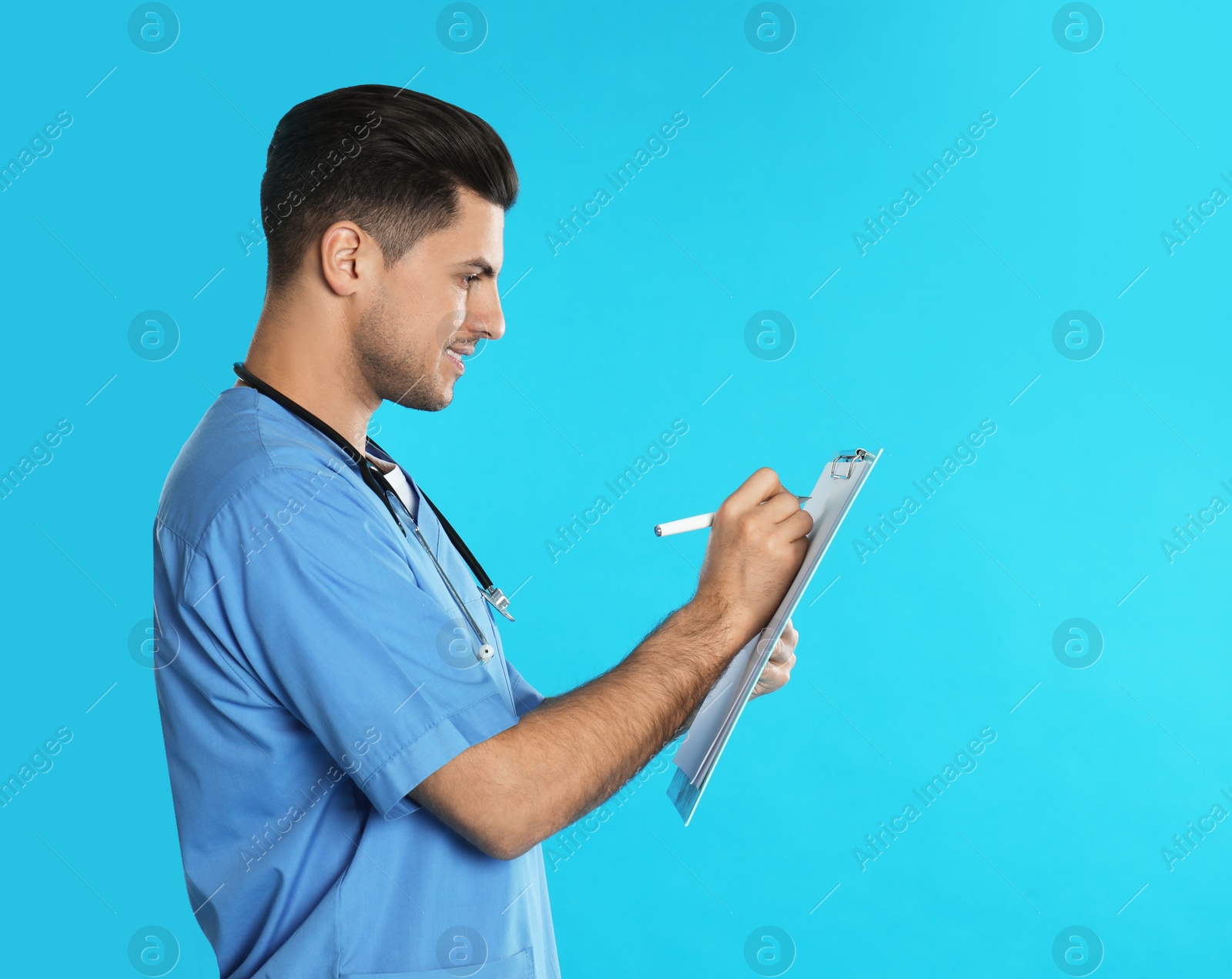 Photo of Doctor with clipboard on blue background. Space for text
