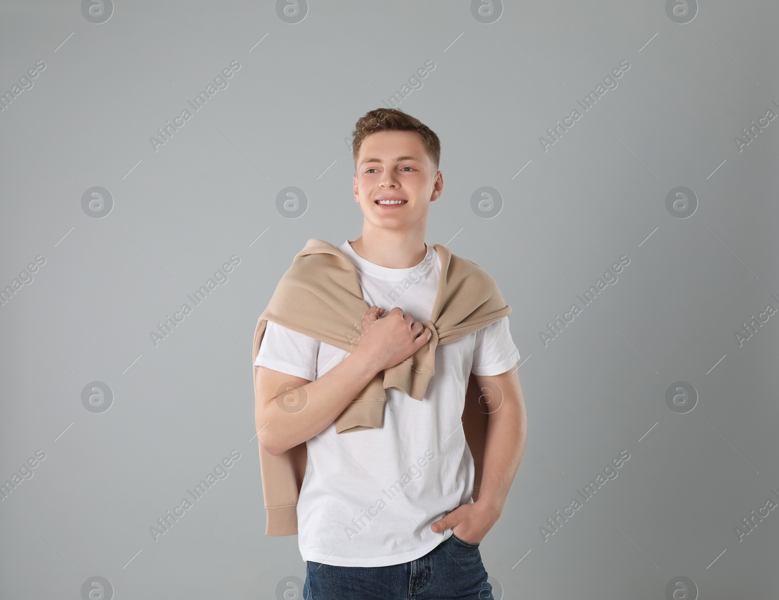 Photo of Portrait of teenage boy on light grey background