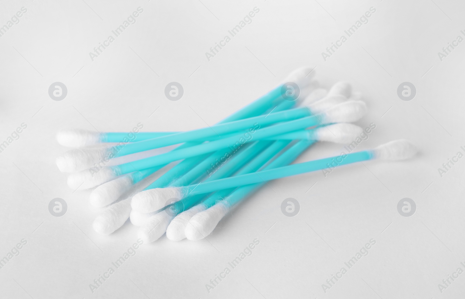 Photo of Heap of clean cotton buds on white background