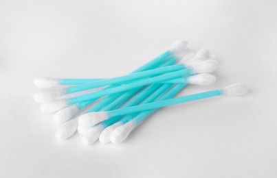 Photo of Heap of clean cotton buds on white background