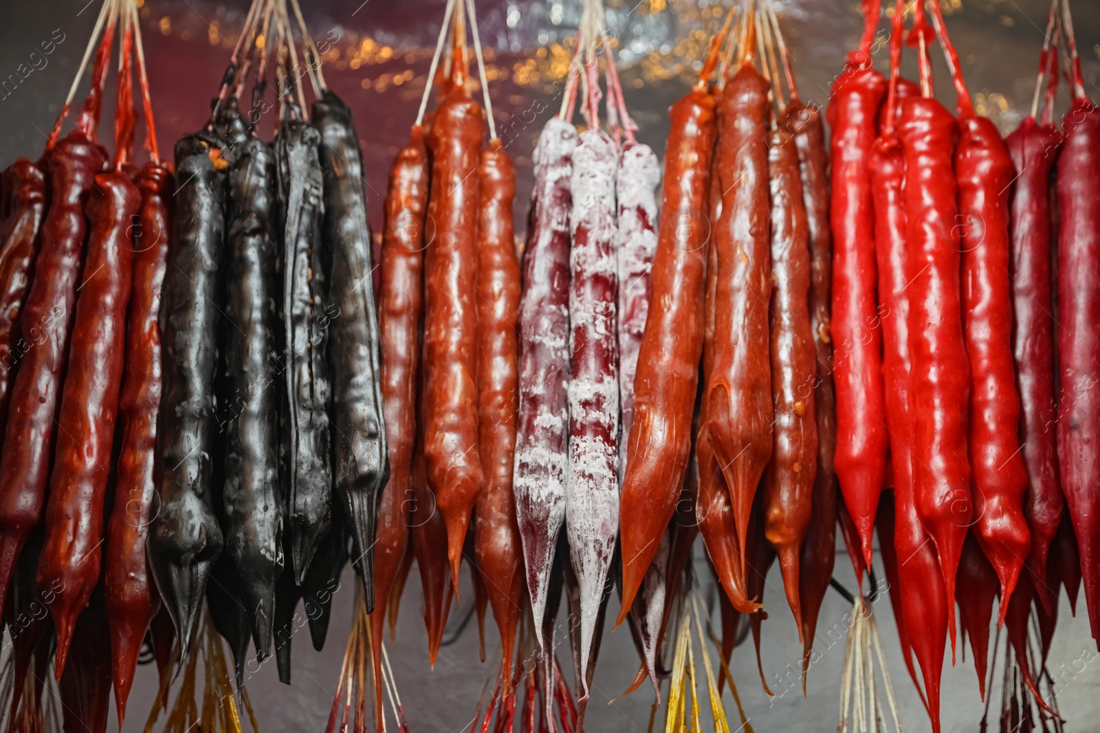 Photo of Bunches of different delicious churchkhelas at market