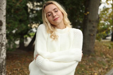 Photo of Beautiful woman in stylish warm sweater outdoors