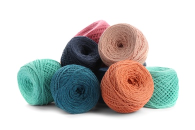 Photo of Clews of colorful knitting threads on white background