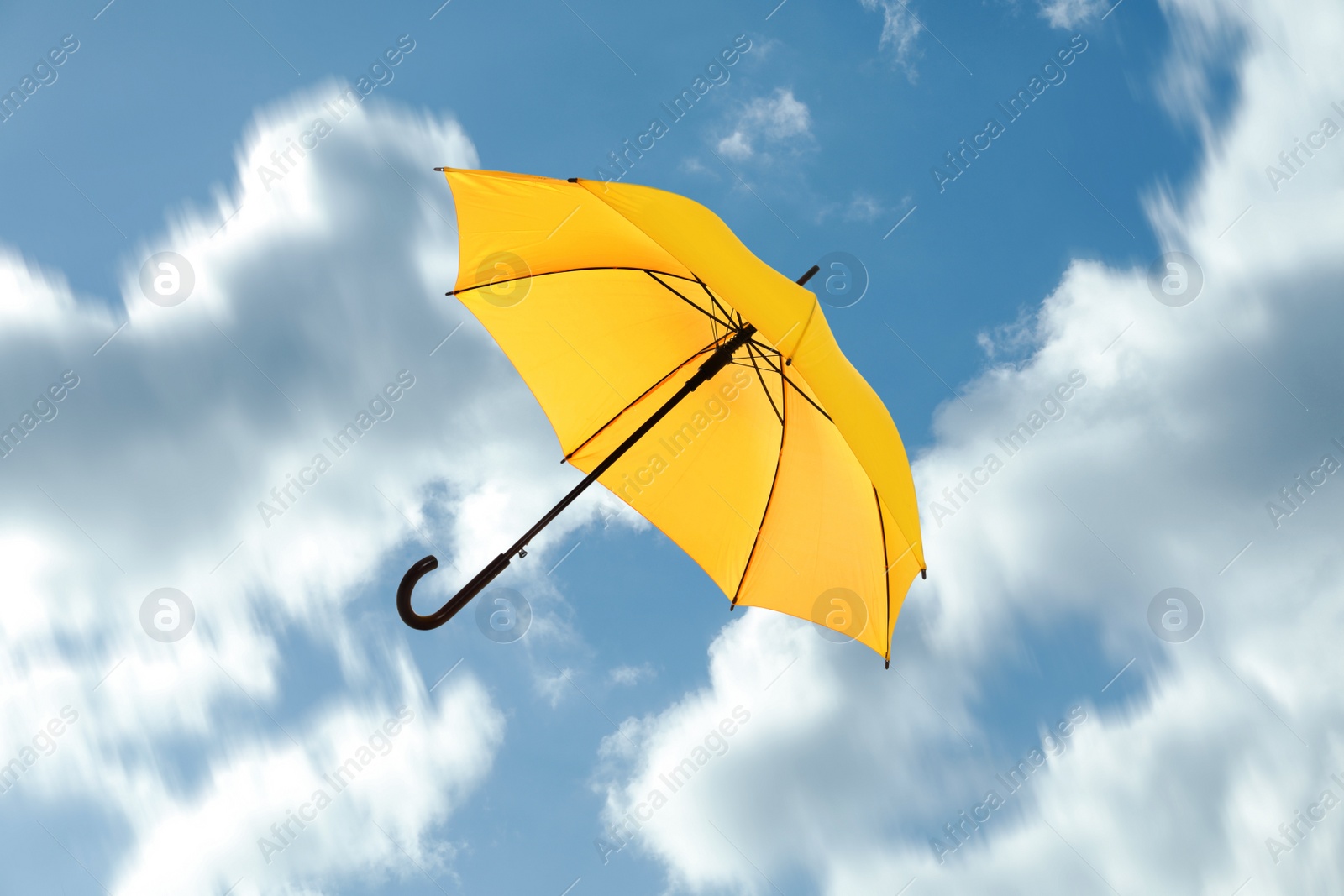 Image of Open umbrella blown by wind gust outdoors