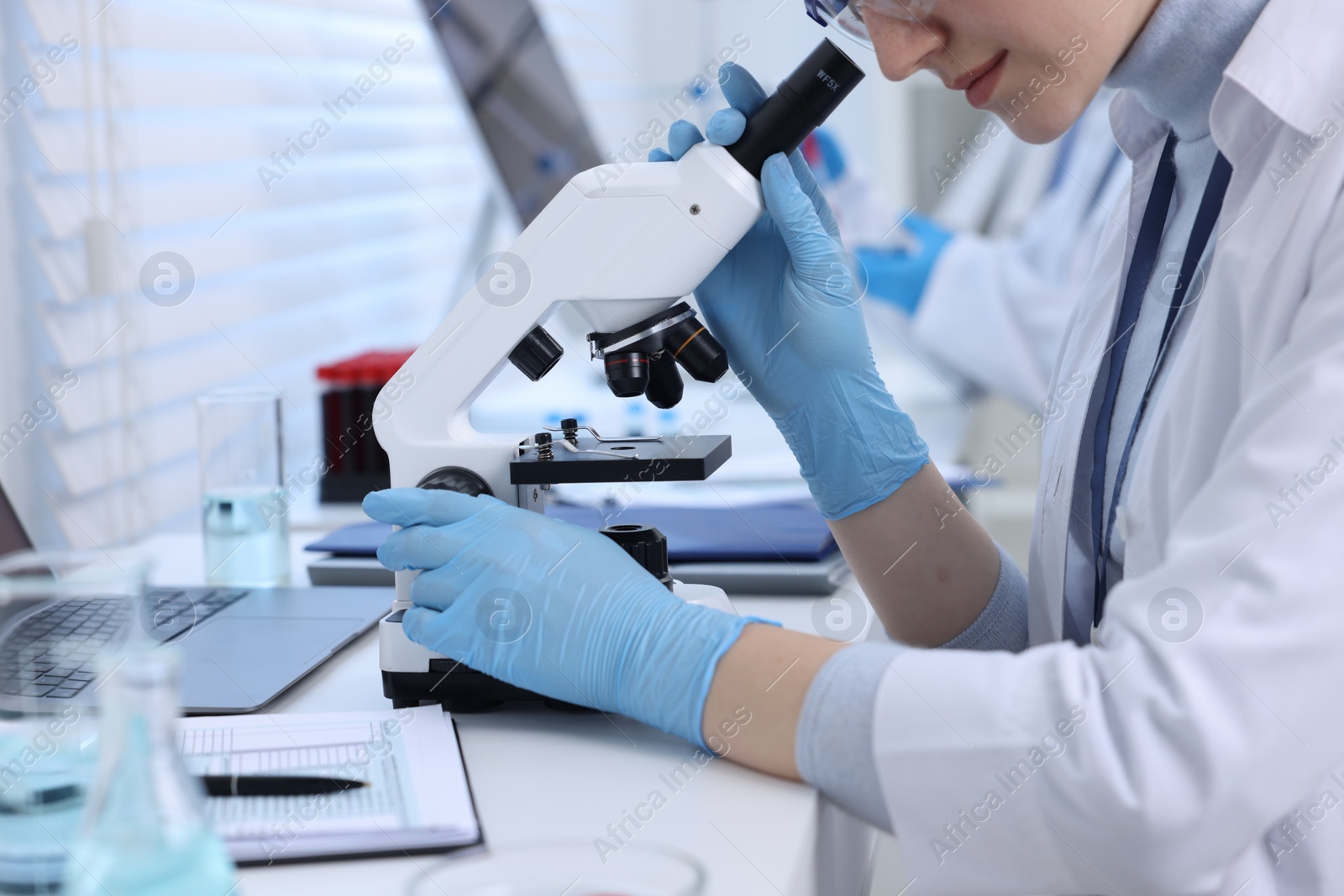 Photo of Scientists working with samples in laboratory, closeup. Medical research