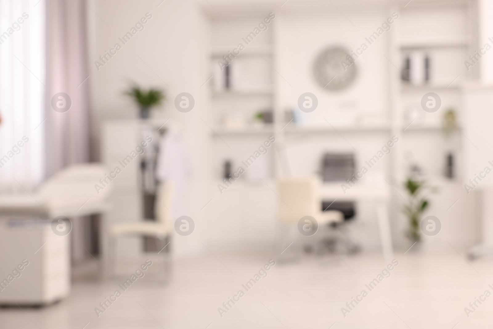 Photo of Blurred view of medical office interior with doctor's workplace